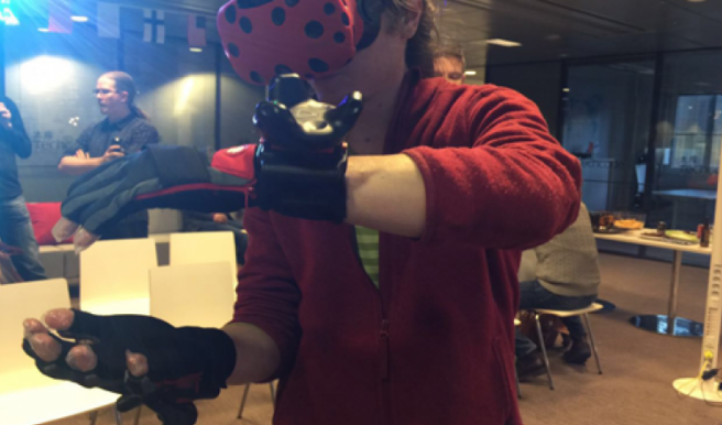 A player wears the Hi5 virtual reality glove by Noitom at TechCode in Finland..